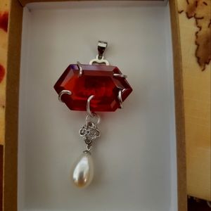 65 carat natural red zircon with natural pearl enhancer.
